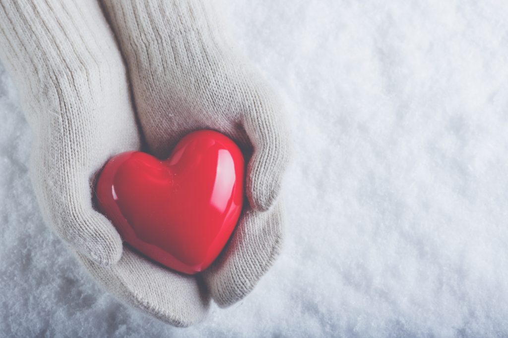 hands holing a ceramic heart